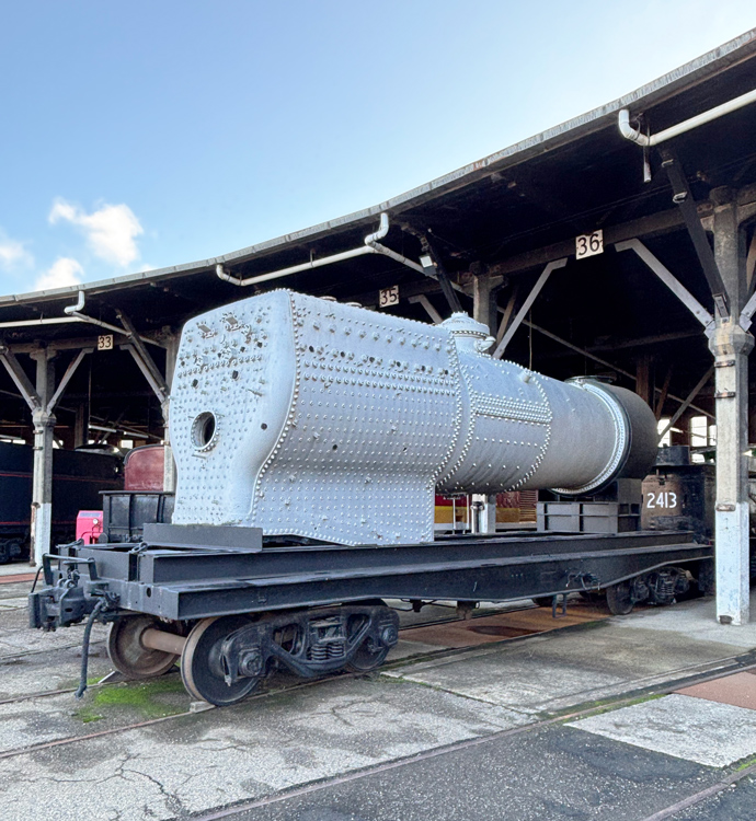 A train car with a large cylinder on it

AI-generated content may be incorrect.