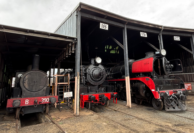 A train depot with trains in it

AI-generated content may be incorrect.