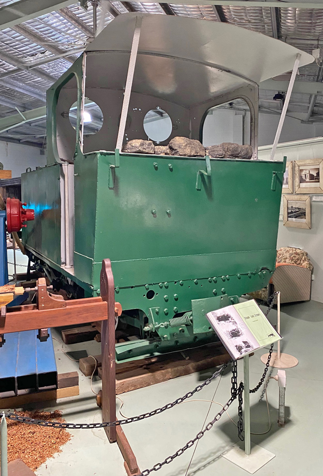 A green train car in a museum

Description automatically generated