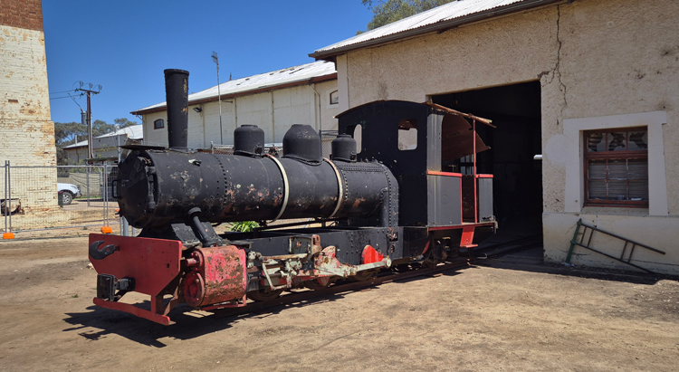 A black train in front of a building

AI-generated content may be incorrect.